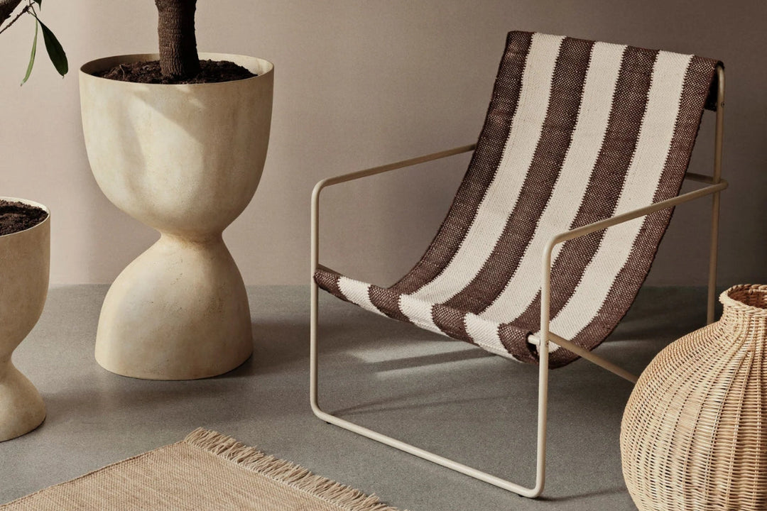 Minimal entryway with floating timber stairs and a low metal shoe rack with wire storage baskets.