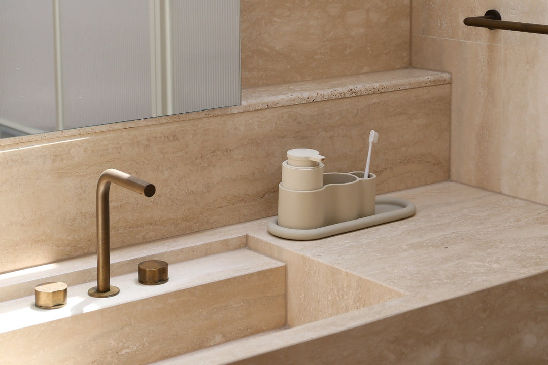 Minimal entryway with floating timber stairs and a low metal shoe rack with wire storage baskets.