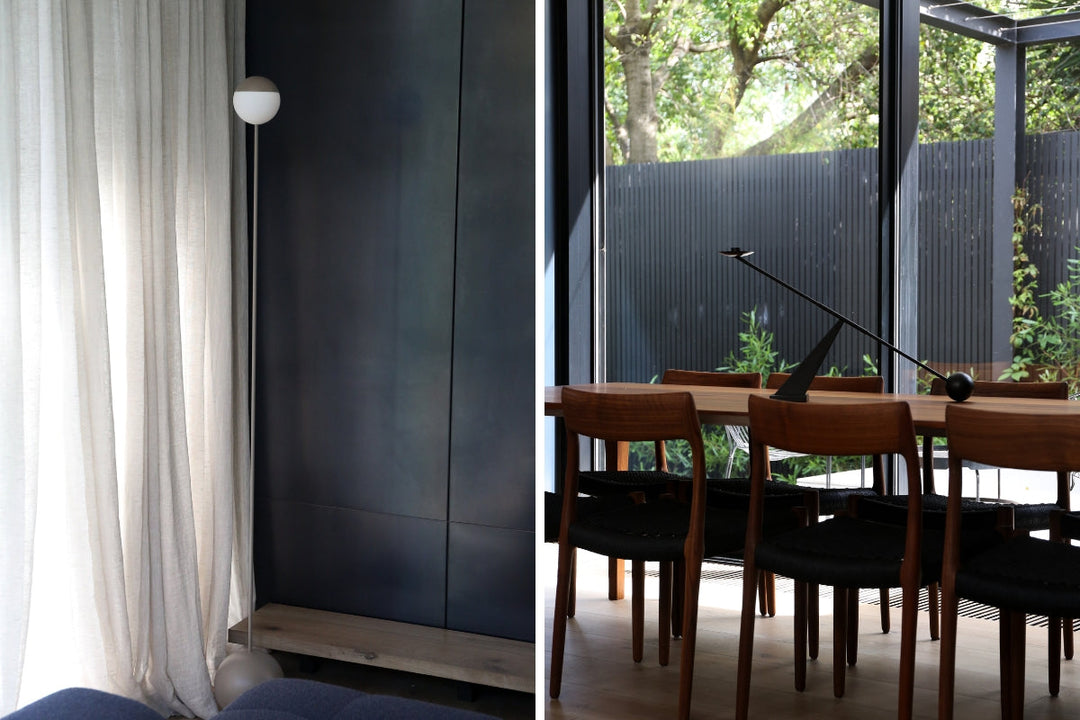 Modern interiors of Hidden House, featuring a minimalist floor lamp against soft curtains and a contemporary dining area with wooden chairs and large glass windows.