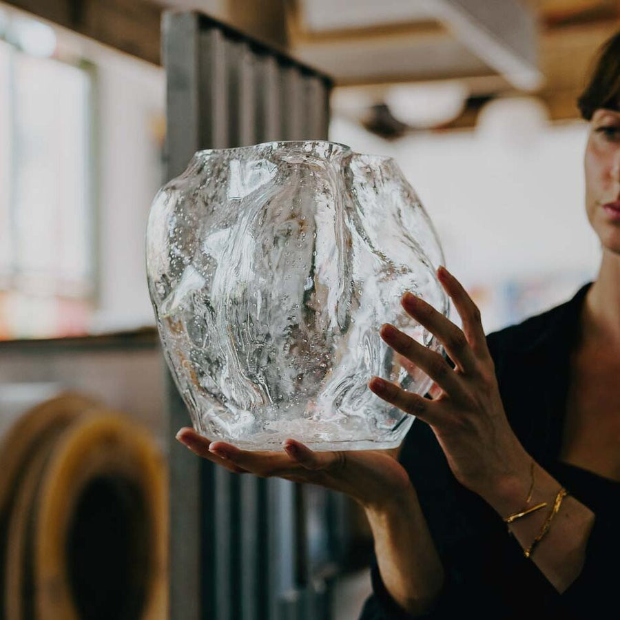 NEW WORKS Blaehr Vase Large, Clear Glass in the hands of a woman.