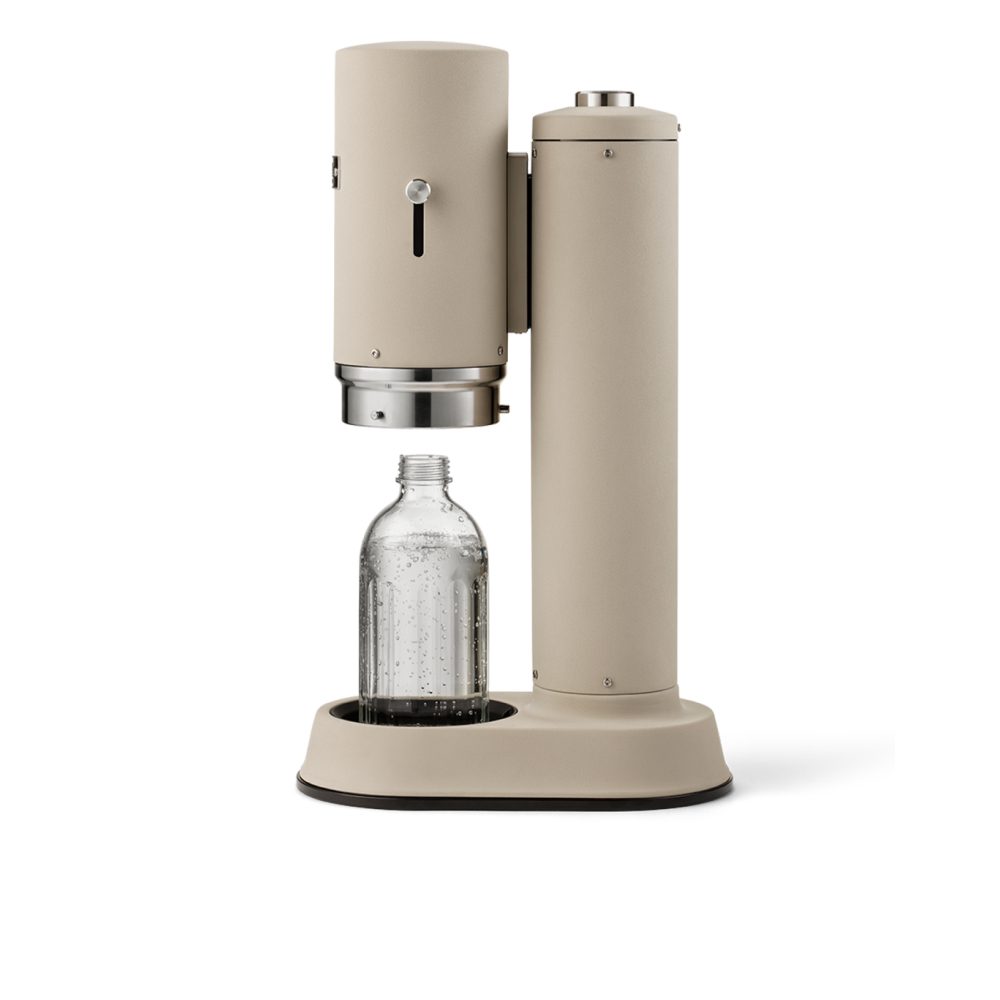 Studio lighting, perspective view of a cannister-shaped carbonator with a glass bottle filled with fizzy water