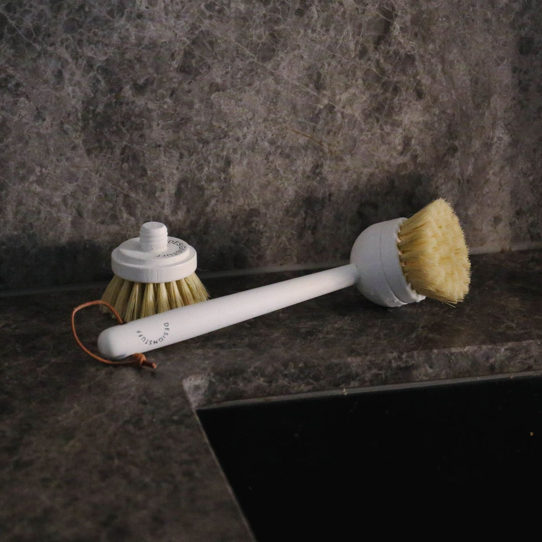 Designstuff Eco Dish brush with a replacement brush head by a sink