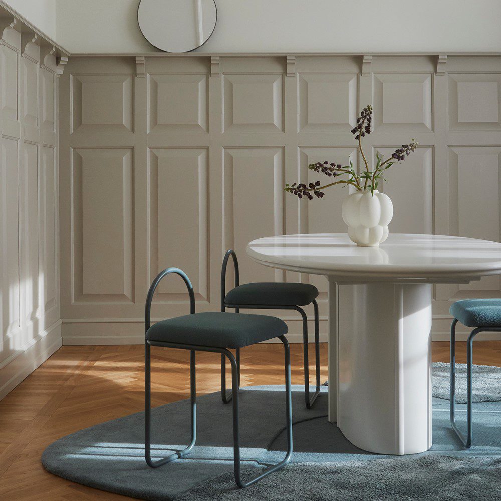 Natural lighting, perspective view of three chairs placed next to a table