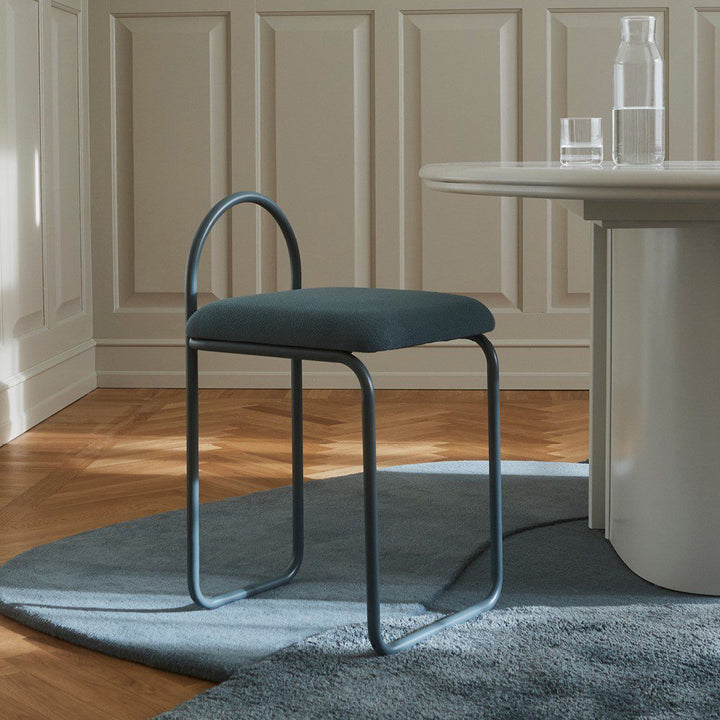 Natural lighting, perspective view of a chair placed next to a table