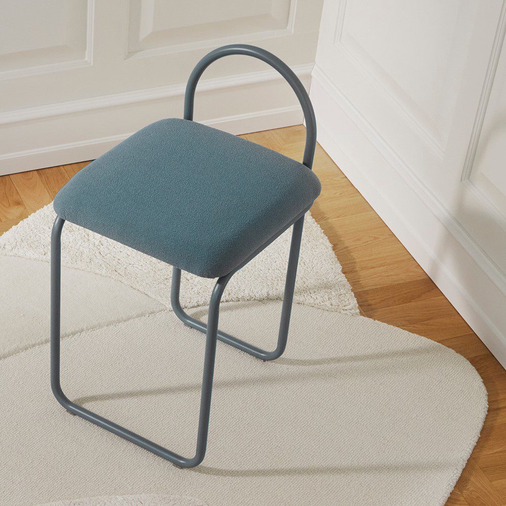 Natural lighting, top view of a chair placed on a rug