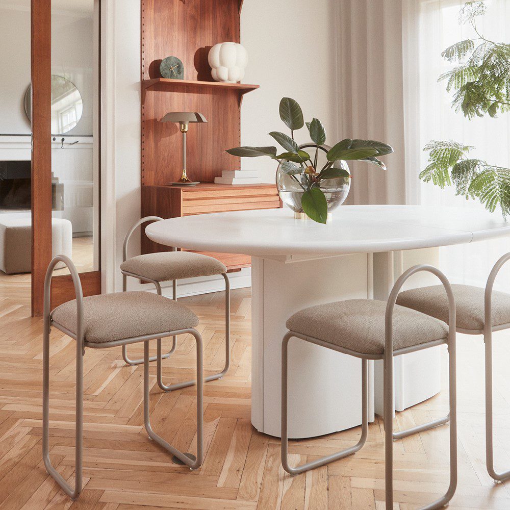 Natural lighting, perspective view of three chairs placed next to a table