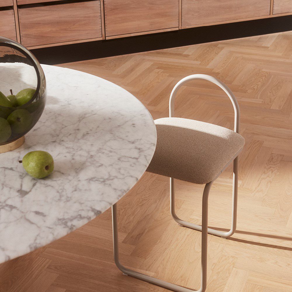 Natural lighting, perspective view of a chair placed next to a table