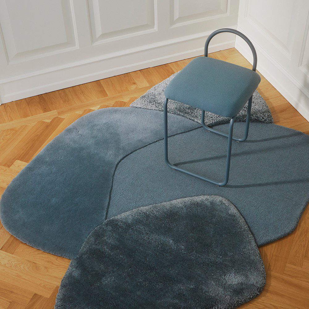 Natural lighting, top view of a rug topped with a chair