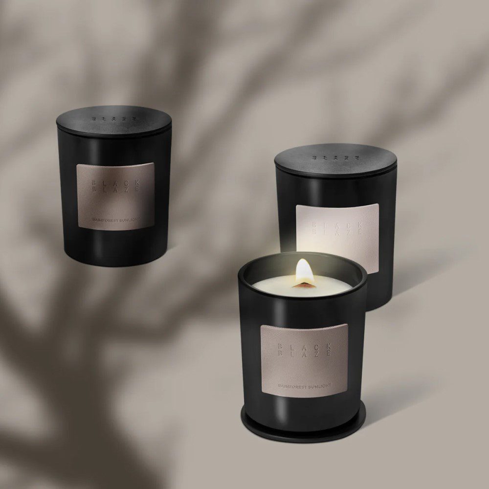 A trio of cylinder-shaped jars of candles placed next to each other.