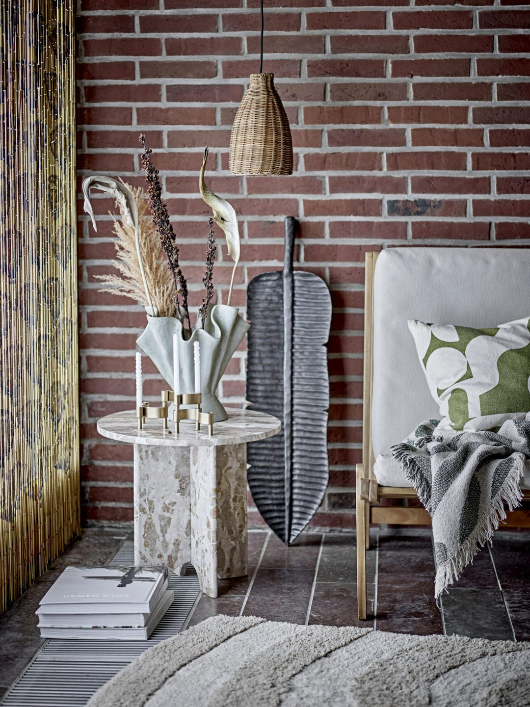 A vase and a candle holder on Jasmia brown marble side table.