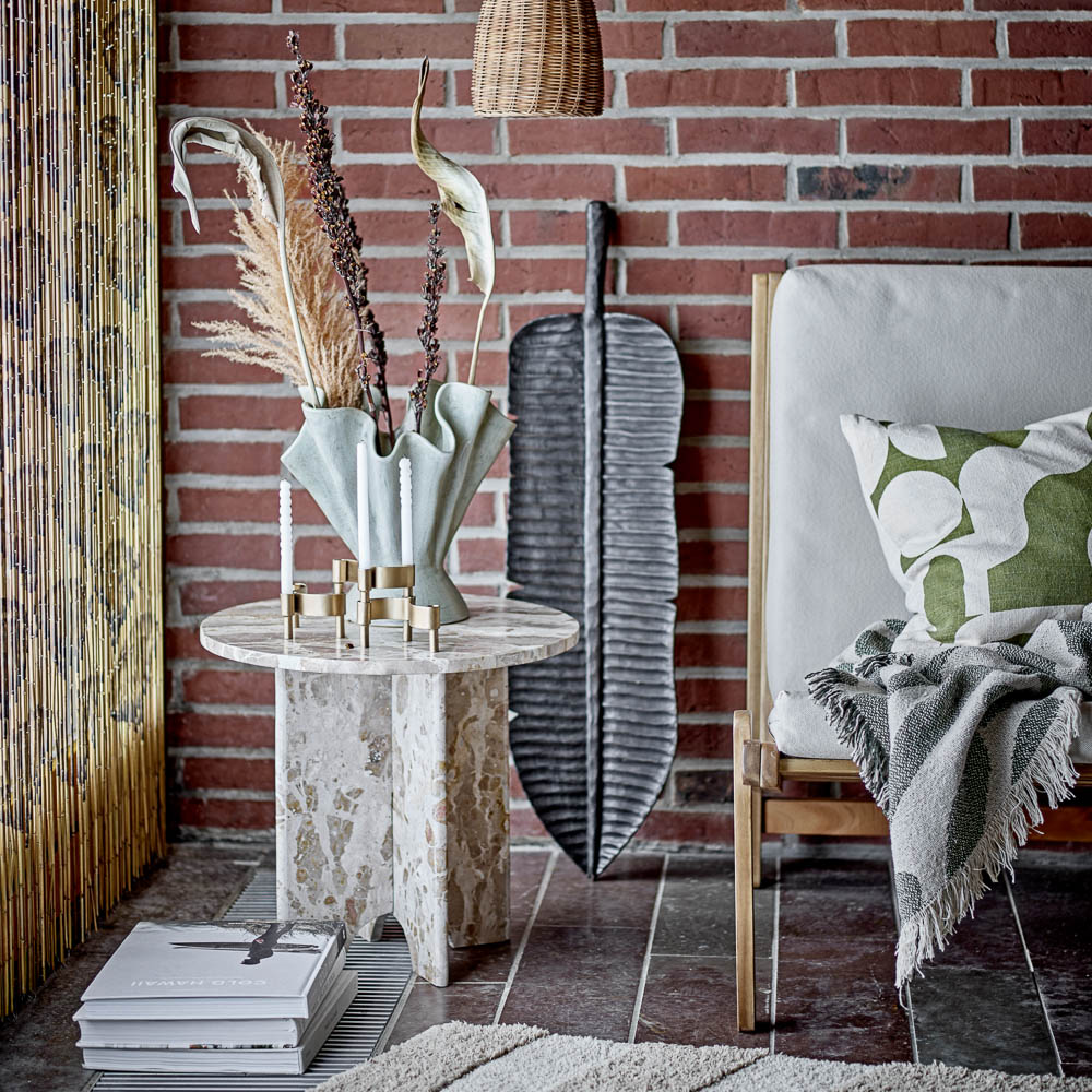 A style image of beautiful sculptural shape and wavy look of Plier stoneware vase by Bloomingville in a Scandi design living room.