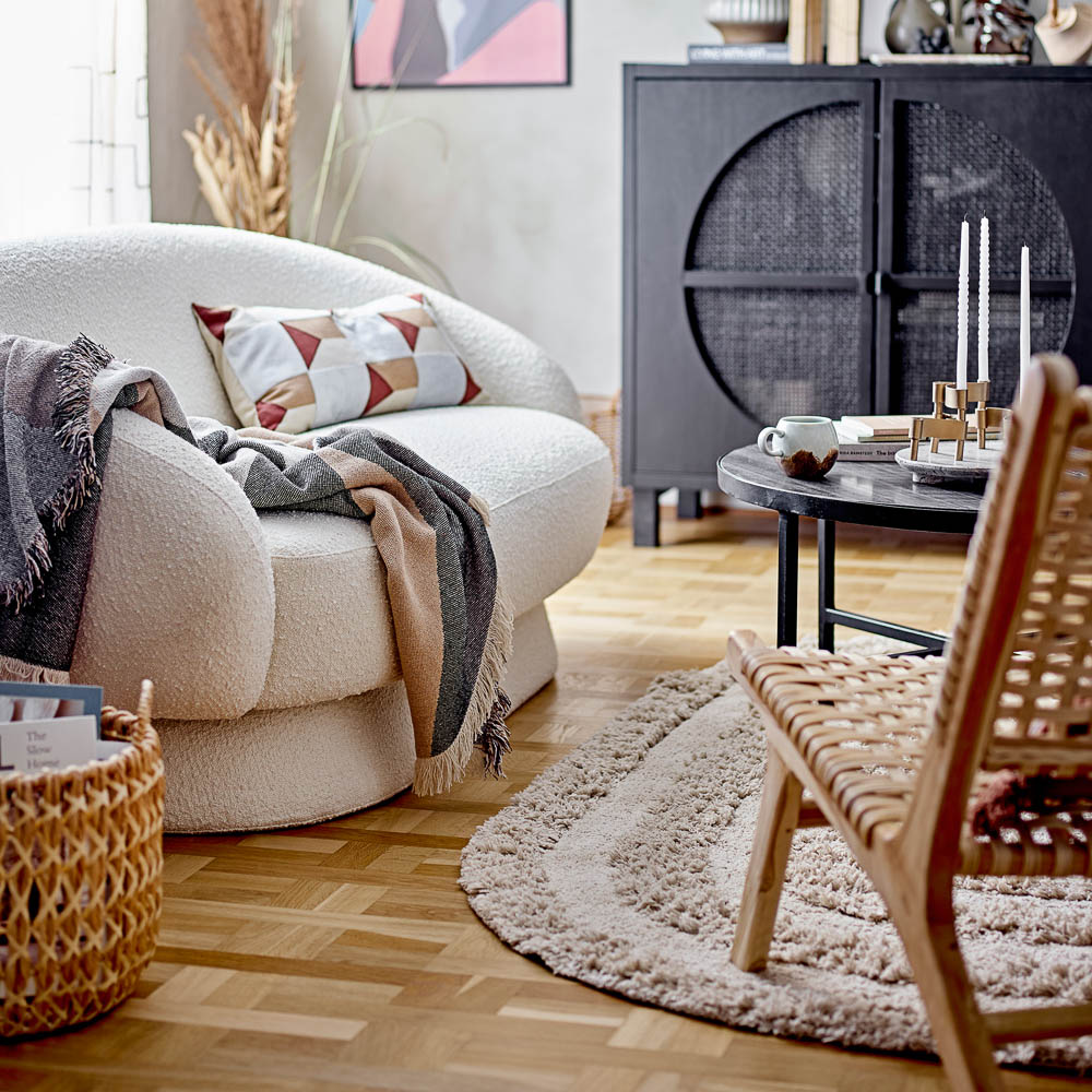 A style image of cotton Turi rug with tufted pattern and a beautiful oval design in a Scandi design lounge room.