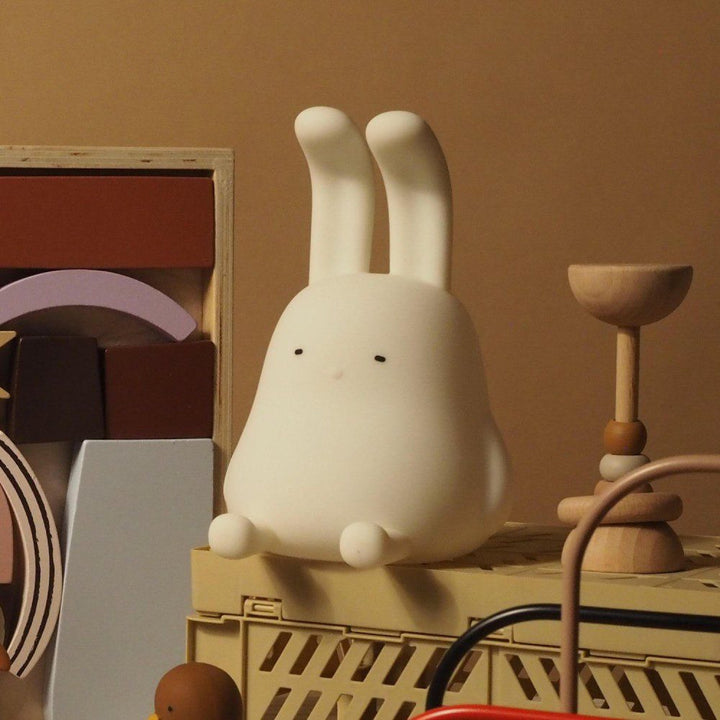 Natural lighting, perspective view of a kids' lamp in the shape of a rabbit.