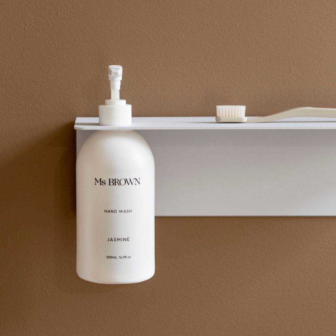 Close up of DESIGNSTUFF Shelf w/ Single Soap Dispenser Holder in White on a brown background