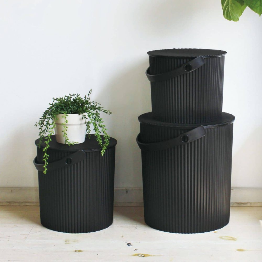 Perspective view, close up shot of black storage bins stacked on top of each other.