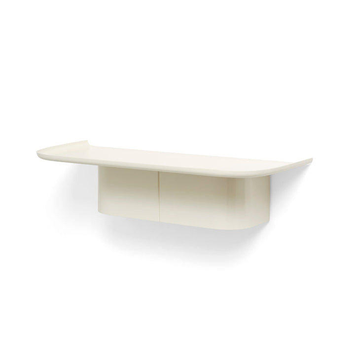 A cream-colored, wall-mounted metal shelf with a curved column on one side, designed for holding items such as kitchen utensils or decorative objects.