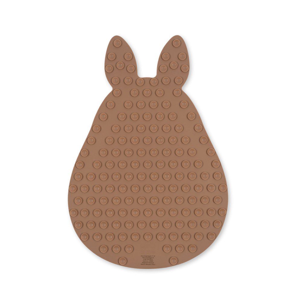 Top view, studio lighting shot of a bunny-shaped rubber bath mat.