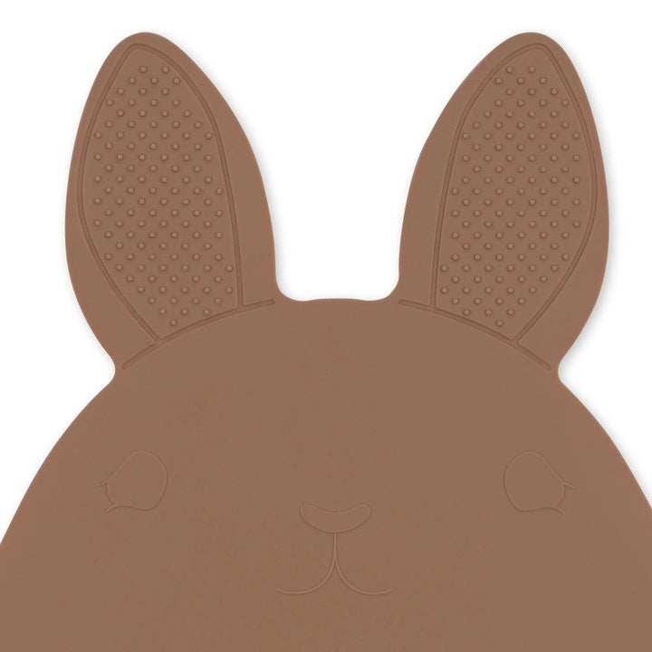 Zoomed in, studio lighting shot of a bunny-shaped rubber bath mat.