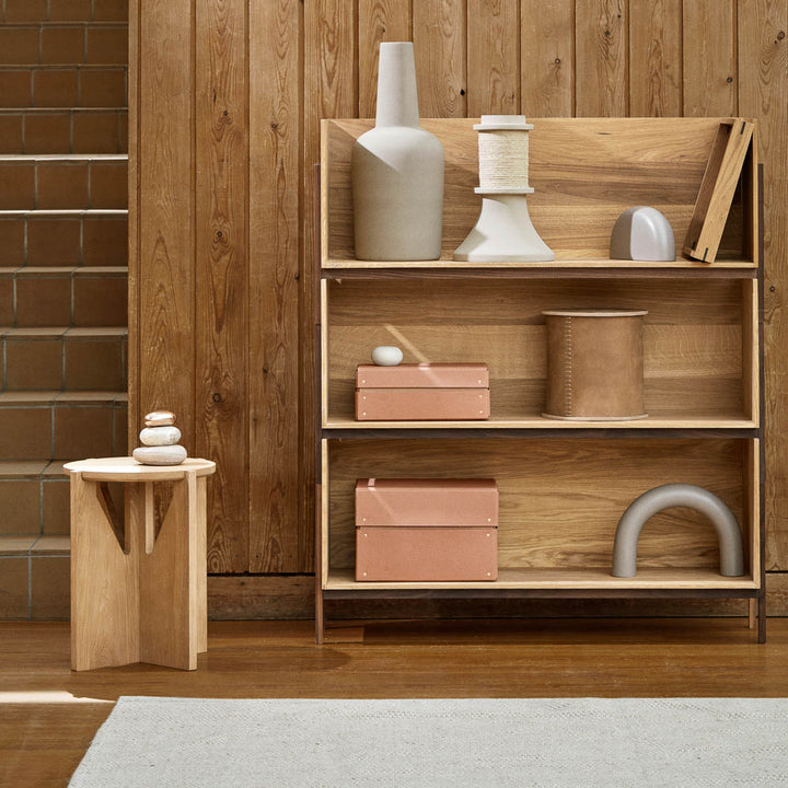 Kristina Dam Studio oak table and a stiched leather box on the shelf