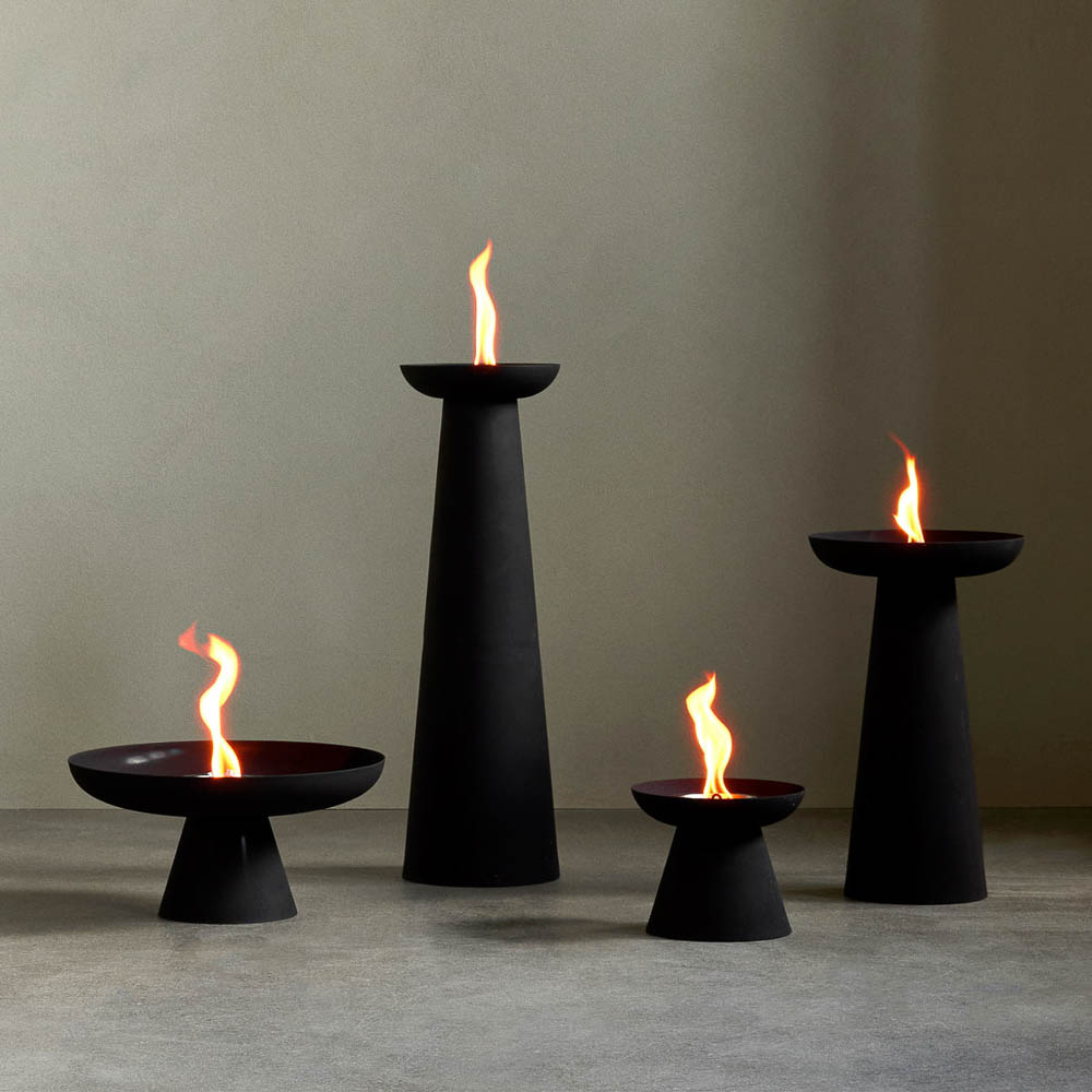 The outdoor flame made from powder-coated steel Meira Oil Lantern by Menu in black with four different sizes.