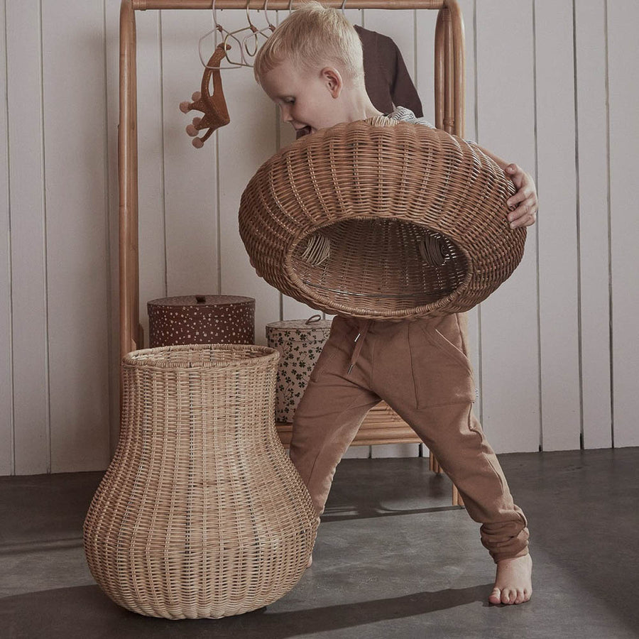 A kid is opening the lid of mushroom basket