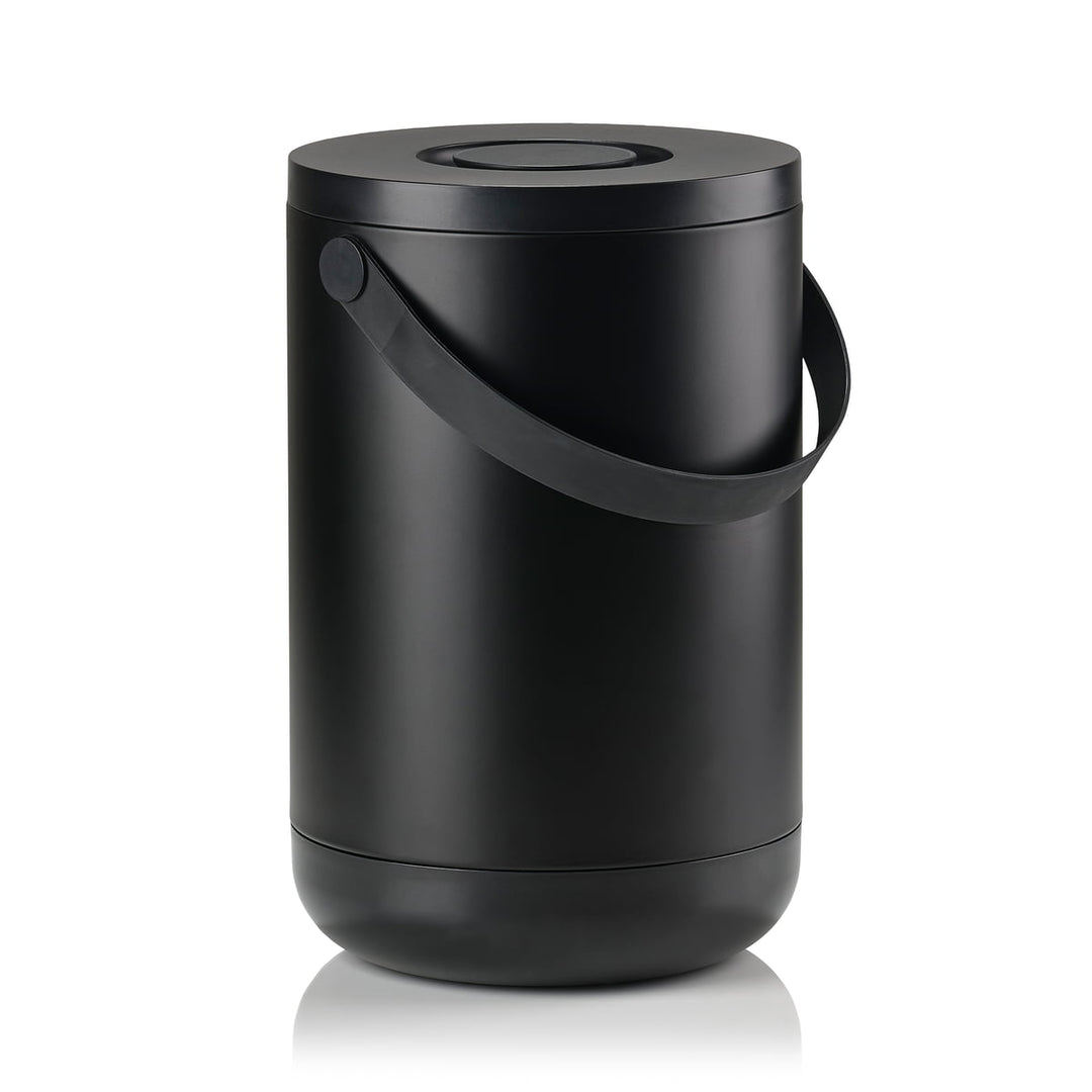 White background, perspective view studio image of a tall, black, cylindrical trash bin with a pail-type handle.