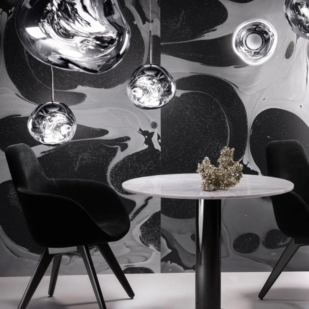 TOM DIXON Melt Mini Pendant Light, Chrome LED, 28cm hanging from the ceiling over a sitting area