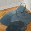 Natural lighting, top view of a rug topped with a chair